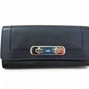 Black Coach swagger slim envelope wallet. Pebbled leather with gold hardware.